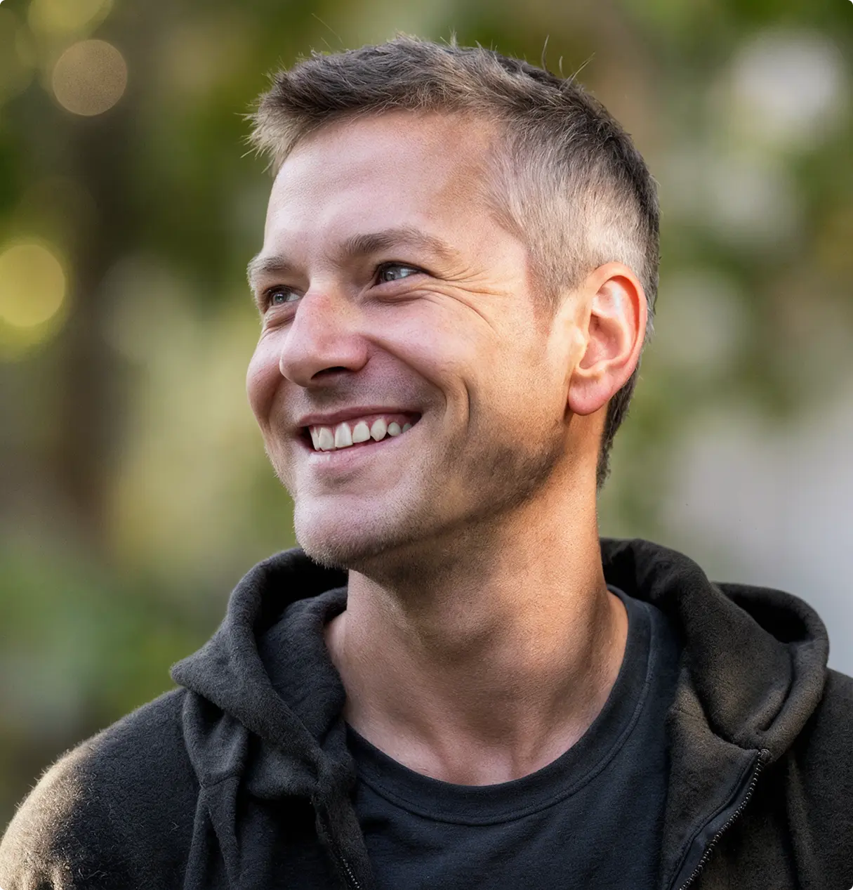 A pixelated image of an orange and white cat lying down, looking to the side, with blurred greenery in the background